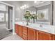 Bathroom with double sink vanity, large mirror and view into the bedroom at 169 Northside Dr., Little River, SC 29566