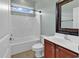 Bathroom showcasing a vanity with dark wooden cabinets, toilet, and a shower-tub combination at 169 Northside Dr., Little River, SC 29566