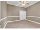 Bedroom features tile flooring, neutral wall paint, a ceiling fan, and a closet for storage at 169 Northside Dr., Little River, SC 29566