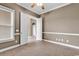Bedroom showcasing tile flooring, neutral wall paint, a ceiling fan, and access to other rooms in the home at 169 Northside Dr., Little River, SC 29566