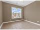 Bedroom showcasing tile flooring, neutral wall paint, and a window bringing in natural light at 169 Northside Dr., Little River, SC 29566