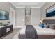 Well-staged bedroom with walk-out to patio, tv and ensuite bath at 169 Northside Dr., Little River, SC 29566