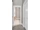 Hallway entrance view of a bathroom with a tiled floor and wood cabinets at 169 Northside Dr., Little River, SC 29566