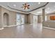 Open-concept living space with tile floors, ceiling fan, tray ceiling, and access to the patio at 169 Northside Dr., Little River, SC 29566