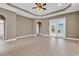 A living area featuring tile floors, archways, tray ceiling, and access to other rooms of the home at 169 Northside Dr., Little River, SC 29566