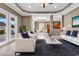 Staged living room featuring stylish furniture, tile flooring, and an open concept layout at 169 Northside Dr., Little River, SC 29566