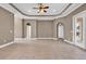 Spacious living room with tile floors, tray ceiling, ceiling fan, and archways leading to hallways at 169 Northside Dr., Little River, SC 29566