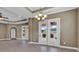Spacious living area with tile flooring, recessed lighting, and French doors leading to the outdoor patio at 169 Northside Dr., Little River, SC 29566