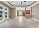 Large living area featuring tile floors, ceiling fan, a tray ceiling, and access to the backyard at 169 Northside Dr., Little River, SC 29566