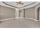 Large living room featuring tile floors, archways, a tray ceiling, and access to multiple rooms at 169 Northside Dr., Little River, SC 29566