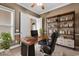 Home office features a sleek desk, shelves, and a comfortable chair for a productive workspace at 169 Northside Dr., Little River, SC 29566