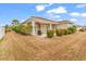 A cozy patio with a chair offers a relaxing outdoor space in this well-maintained yard with manicured shrubs at 169 Northside Dr., Little River, SC 29566