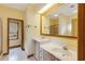 Well-lit bathroom featuring double sinks, tile floors and a framed mirror at 20 Brassie Dr., Carolina Shores, NC 28467