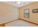 Cozy bedroom with neutral carpeting, a ceiling fan, and natural light from a window overlooking the backyard at 20 Brassie Dr., Carolina Shores, NC 28467