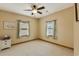 Bedroom with ceiling fan, carpet, and two windows with curtains at 20 Brassie Dr., Carolina Shores, NC 28467