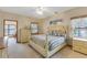 Cozy bedroom featuring carpet floors, a ceiling fan and a view to the exterior at 20 Brassie Dr., Carolina Shores, NC 28467