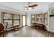 Bright dining area with wood-look flooring, large windows, a decorative ceiling fan, and stylish furnishings at 20 Brassie Dr., Carolina Shores, NC 28467
