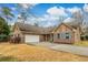 Charming brick home featuring a spacious driveway, two car garage and blue shutters at 20 Brassie Dr., Carolina Shores, NC 28467