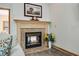 Close-up of the fireplace, showcasing the stone surround, mantel, and the artwork above at 20 Brassie Dr., Carolina Shores, NC 28467