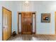 Elegant foyer with hardwood floors, decorative mirror, wooden doors and modern lighting at 20 Brassie Dr., Carolina Shores, NC 28467