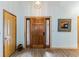 Inviting foyer with wood-look flooring, a decorative mirror, and a wooden front door with sidelights at 20 Brassie Dr., Carolina Shores, NC 28467