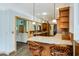 Open kitchen featuring granite countertops, pendant lighting and seating at the breakfast bar at 20 Brassie Dr., Carolina Shores, NC 28467