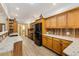 Spacious kitchen with wood cabinets, wood backsplash, stainless steel appliances and granite countertops at 20 Brassie Dr., Carolina Shores, NC 28467