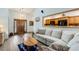 Comfortable living room featuring wood floors, a pass-through to the kitchen, and a large sofa at 20 Brassie Dr., Carolina Shores, NC 28467