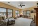 Bright sitting area with large windows, comfortable seating, and views of the landscaped yard at 20 Brassie Dr., Carolina Shores, NC 28467