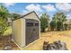 Durable storage shed in backyard with double doors, perfect for storing gardening tools, lawn equipment, and outdoor essentials at 20 Brassie Dr., Carolina Shores, NC 28467