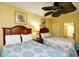 Cozy bedroom with two beds, overhead fan, and bright, beachy decor at 2007 S Ocean Blvd. # 1106, Myrtle Beach, SC 29577