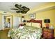 Relaxing bedroom with a ceiling fan, inviting decor, and a peek into the ensuite bathroom at 2007 S Ocean Blvd. # 1106, Myrtle Beach, SC 29577