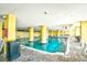 Inviting indoor pool for year-round swimming, surrounded by bright yellow pillars and ample seating at 2007 S Ocean Blvd. # 1106, Myrtle Beach, SC 29577