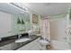 Bathroom features a granite countertop, white sink, large mirror, bathtub and shower with a tropical theme at 2007 S Ocean Blvd. # 1106, Myrtle Beach, SC 29577