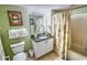 Bathroom features a sink, vanity, granite counter, framed mirror, shower with curtain and adjacent toilet at 2007 S Ocean Blvd. # 1106, Myrtle Beach, SC 29577