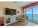 Comfortable bedroom with a dresser, TV, and access to a private balcony overlooking the ocean at 2007 S Ocean Blvd. # 1106, Myrtle Beach, SC 29577