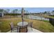 Backyard patio features a table and chairs overlooking a serene pond; perfect for outdoor dining at 253 Forestbrook Cove Circle, Myrtle Beach, SC 29588