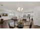 Open-concept dining area and kitchen featuring wood flooring, pendant lighting, and stainless steel appliances at 253 Forestbrook Cove Circle, Myrtle Beach, SC 29588