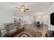 Open-concept living room featuring a ceiling fan, neutral color palette, and wood flooring at 253 Forestbrook Cove Circle, Myrtle Beach, SC 29588