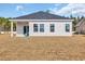 Exterior of the home featuring a backyard with a covered patio and lawn at 264 Palmetto Sand Loop, Conway, SC 29527