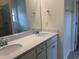 Bathroom vanity with double sinks, white countertop, and a large mirror reflecting the shower and toilet area at 264 Palmetto Sand Loop, Conway, SC 29527