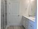 Bright bathroom with a double sink vanity, a white door, and a glass shower with neutral colored tile at 264 Palmetto Sand Loop, Conway, SC 29527