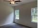 Bedroom showcasing two windows with outdoor views, a ceiling fan, carpeted flooring, and neutral-toned walls at 264 Palmetto Sand Loop, Conway, SC 29527