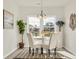 Bright dining area with a white table, elegant chairs, and views to the outdoors at 264 Palmetto Sand Loop, Conway, SC 29527