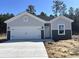 Charming single-Gathering home featuring a pristine white garage door and manicured lawn at 264 Palmetto Sand Loop, Conway, SC 29527