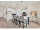 Bright kitchen with white cabinets, an island with bar seating, and a blue backsplash at 264 Palmetto Sand Loop, Conway, SC 29527
