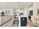 Bright kitchen with white cabinets, black accents, and a kitchen island with bar stool seating at 264 Palmetto Sand Loop, Conway, SC 29527
