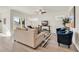 Spacious living room with a beige sofa, blue armchairs, and a sliding glass door at 264 Palmetto Sand Loop, Conway, SC 29527