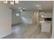 Bright, open-concept living space featuring pendant lights, wood flooring, and a modern kitchen with a breakfast bar at 264 Palmetto Sand Loop, Conway, SC 29527