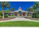 Attractive clubhouse featuring a manicured lawn, symmetrical palm trees and well-maintained landscaping at 2840 Mcleod Ln., Myrtle Beach, SC 29588